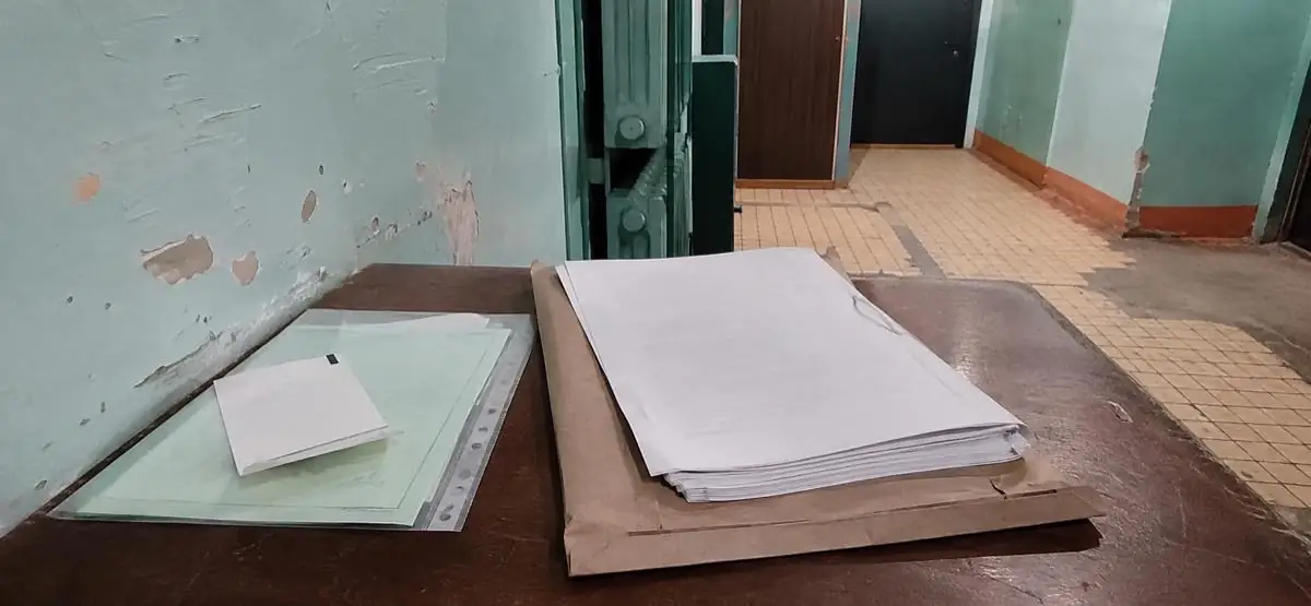 Папки документов и чек-лист на столе в коридоре суда — подготовка к проверке обстоятельств дела